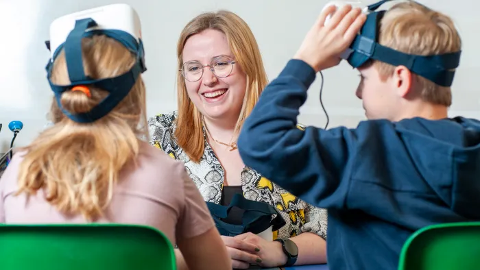 Teacher helping students adjust their ClassVR Xplorer headsets